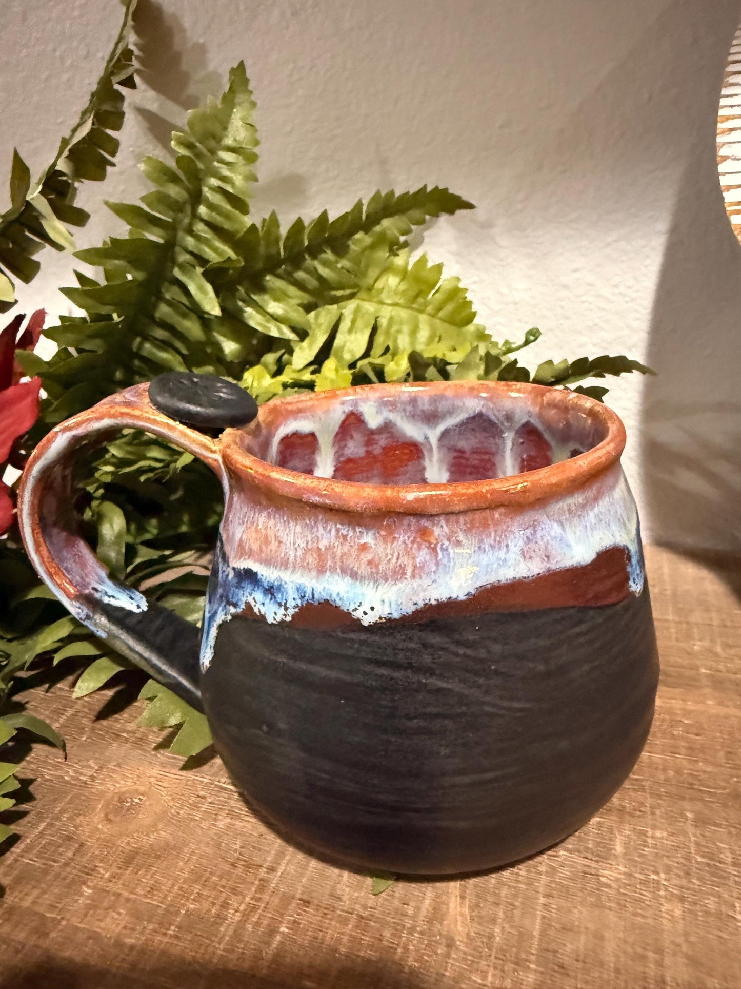 Black and purples stoneware mug .